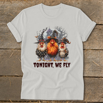 Three chickens in witch hats and a spooky background with text.