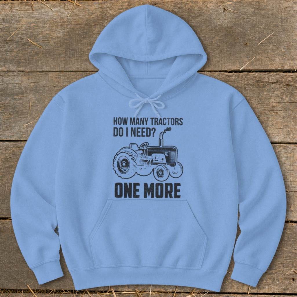 Light blue hoodie with black tractor graphic and text "How Many Tractors Do I Need? One More."
