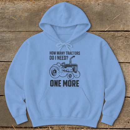 Light blue hoodie with black tractor graphic and text "How Many Tractors Do I Need? One More."