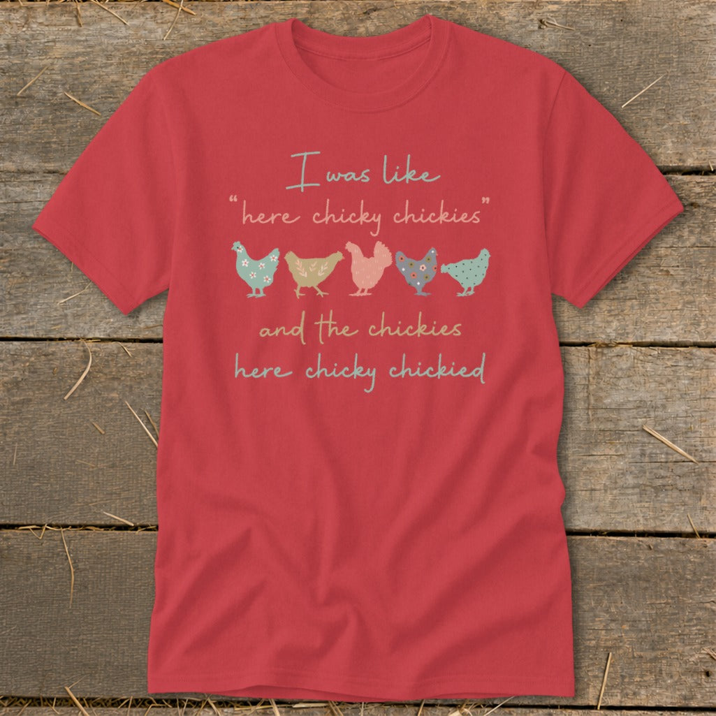 Red t-shirt with text "I was like 'here chicky chickies' and the chickies here chicky chickied" and graphic chickens.