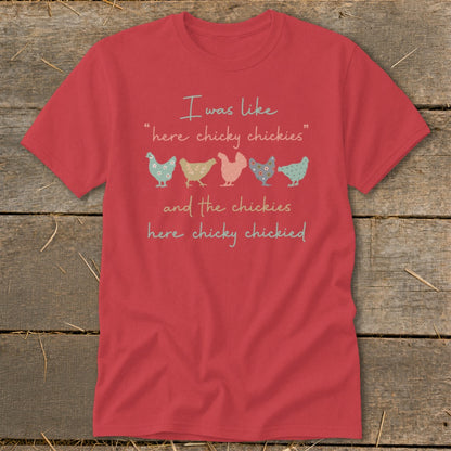 Red t-shirt with text "I was like 'here chicky chickies' and the chickies here chicky chickied" and graphic chickens.