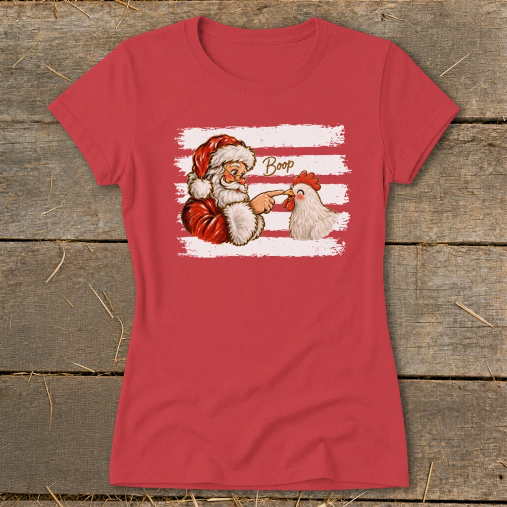 Santa playfully booping a chicken's beak on a red t-shirt.