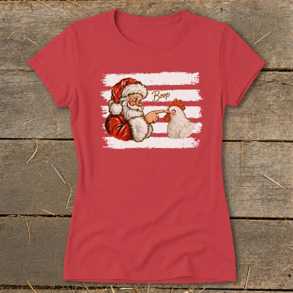 Santa playfully booping a chicken's beak on a red t-shirt.