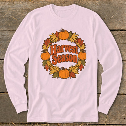 White long-sleeve shirt with "Harvest Season" text in a pumpkin and leaf wreath.