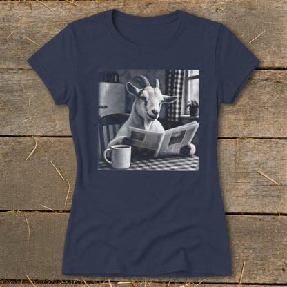 Dark blue short-sleeved t-shirt featuring a black and white graphic of a goat reading a newspaper at a table with a coffee mug.