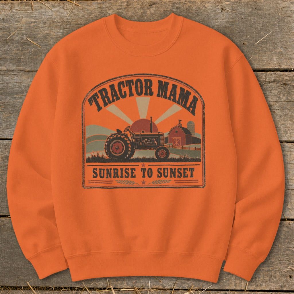 Orange sweatshirt with a distressed graphic of a tractor, barn, and sunset.