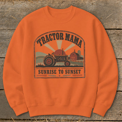 Orange sweatshirt with a distressed graphic of a tractor, barn, and sunset.