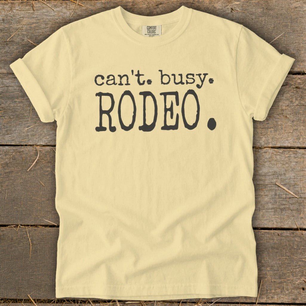 Light yellow t-shirt with black text "can't. busy. RODEO."
