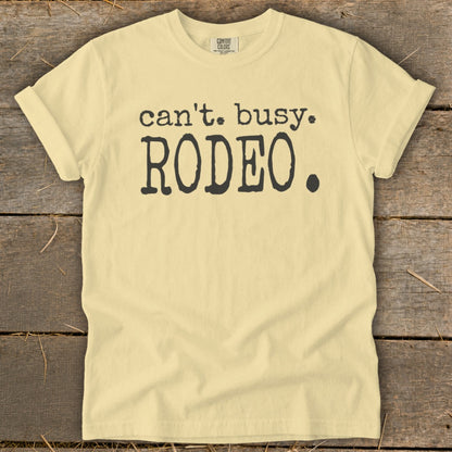 Light yellow t-shirt with black text "can't. busy. RODEO."