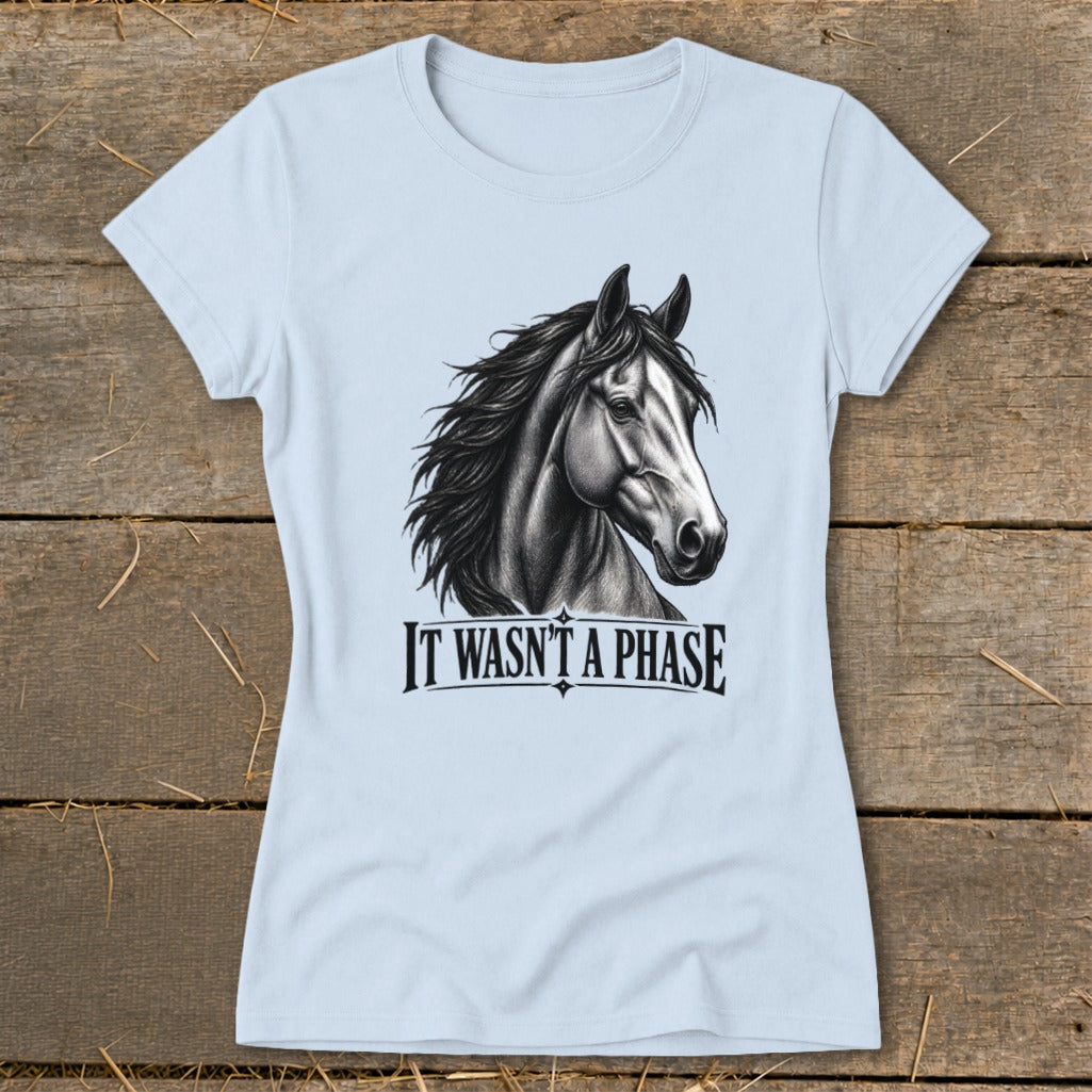 Light blue t-shirt with a charcoal drawing of a horse head and the text "IT WASN'T A PHASE".