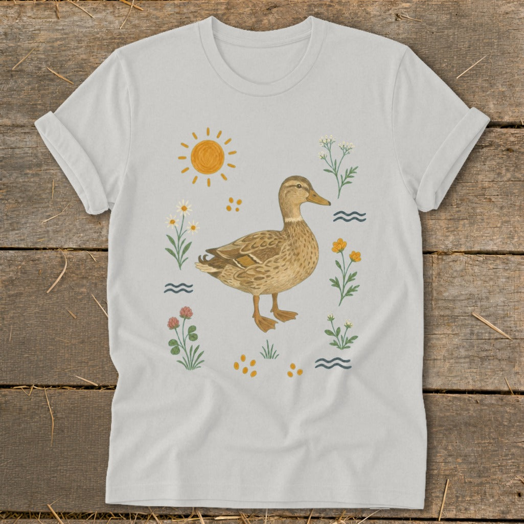 White t-shirt with a brown duck illustration surrounded by flowers and a sun.