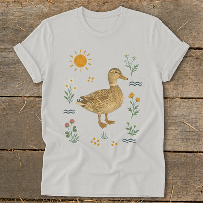 White t-shirt with a brown duck illustration surrounded by flowers and a sun.