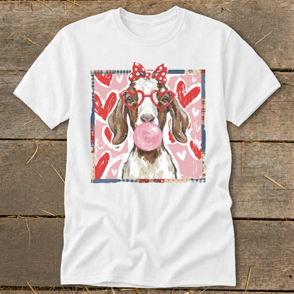 Goat wearing heart glasses and a bow, blowing a pink bubble gum bubble.