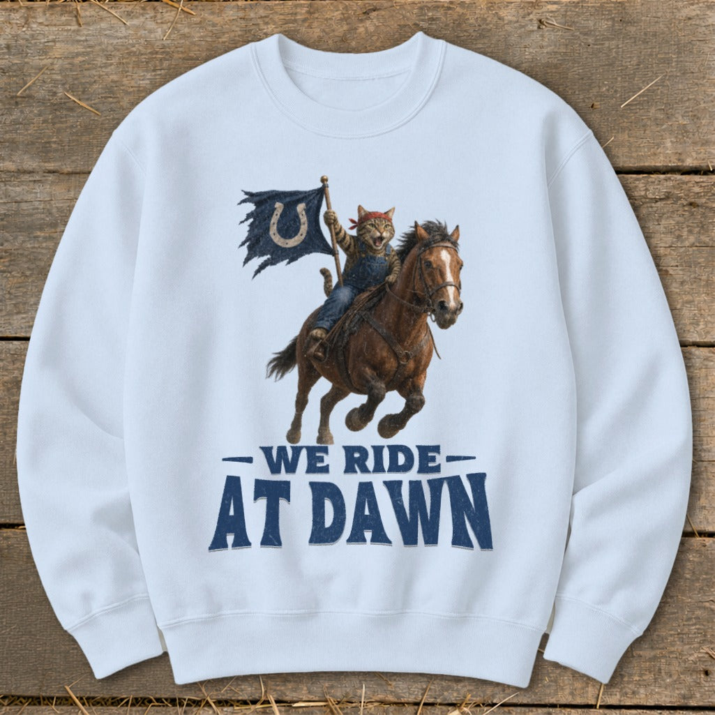 Cat in denim overalls riding a horse, holding a flag with a horseshoe logo. Text reads "We Ride At Dawn".