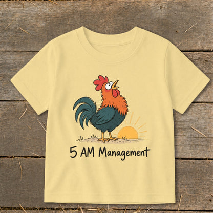 Yellow t-shirt with cartoon rooster crowing at sunrise and text "5 AM Management".