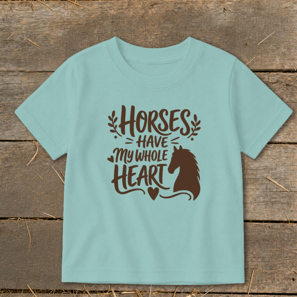 Light blue t-shirt with brown text reading "Horses Have My Whole Heart" and a horse silhouette.