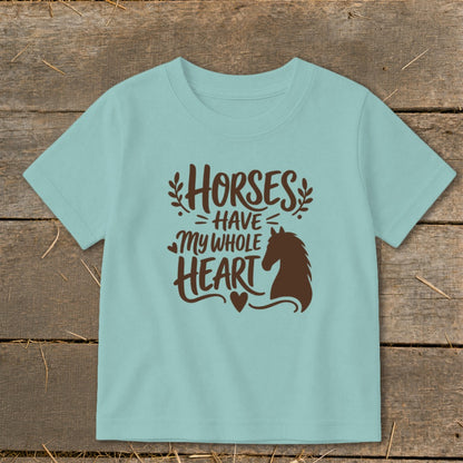 Light blue t-shirt with brown text reading "Horses Have My Whole Heart" and a horse silhouette.