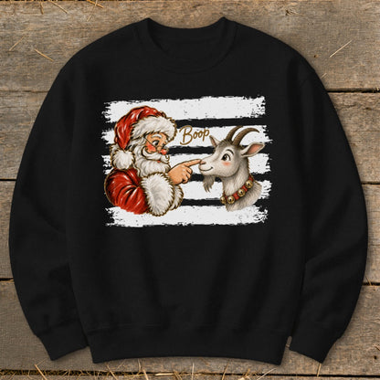 Santa touching a goat's nose with text "Boop" on a black sweatshirt.