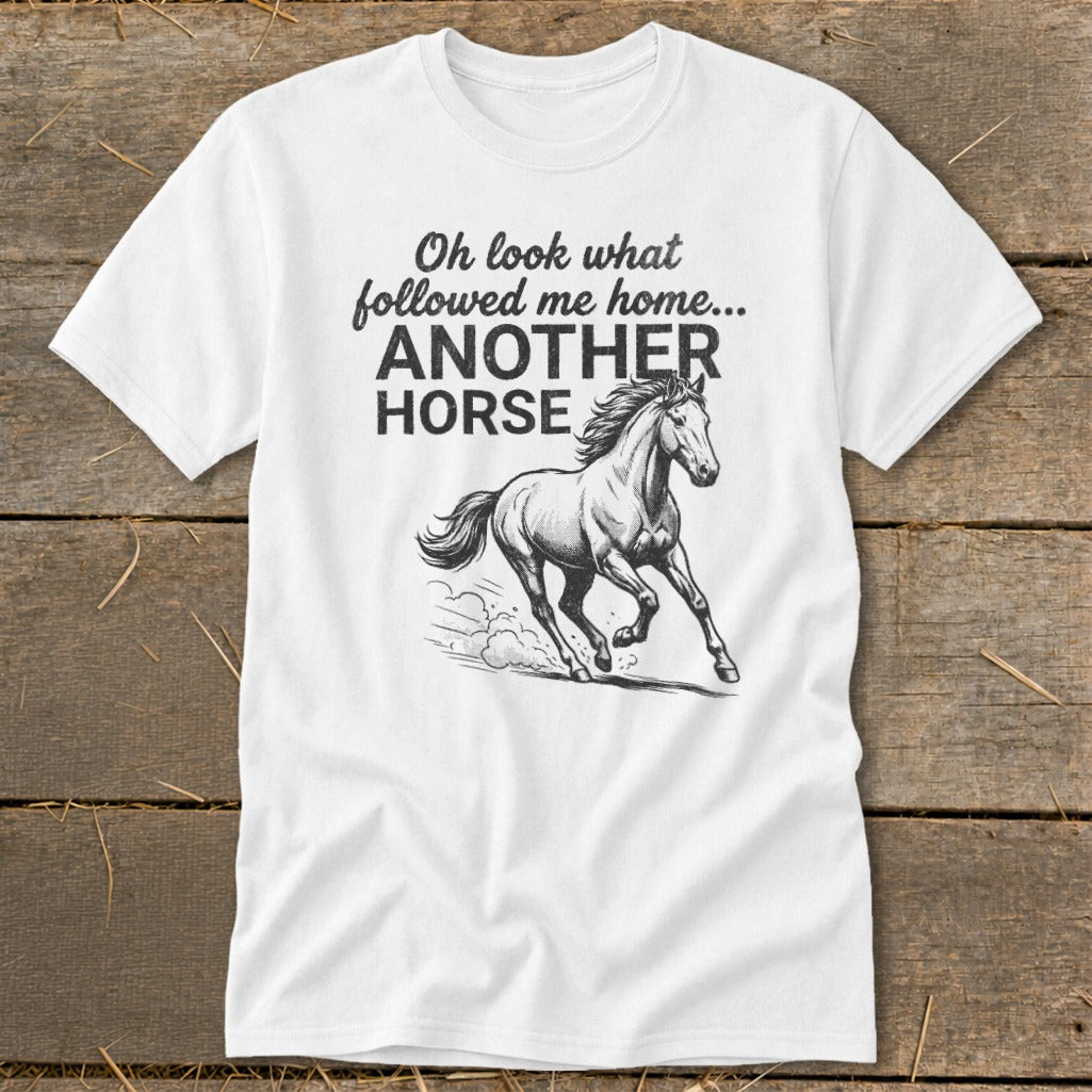 White t-shirt with text "Oh look what followed me home... ANOTHER HORSE" and a running horse graphic.