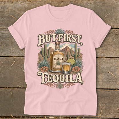Pink t-shirt with "But First Tequila" graphic featuring a tequila bottle and shot.