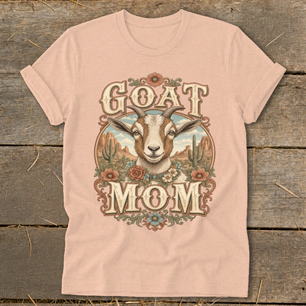 Goat Mom graphic with goat, cacti, and flowers on a pink t-shirt.