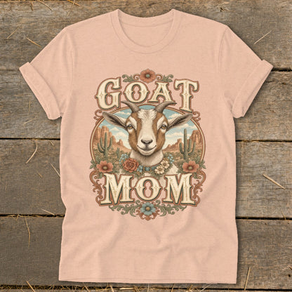Goat Mom graphic with goat, cacti, and flowers on a pink t-shirt.