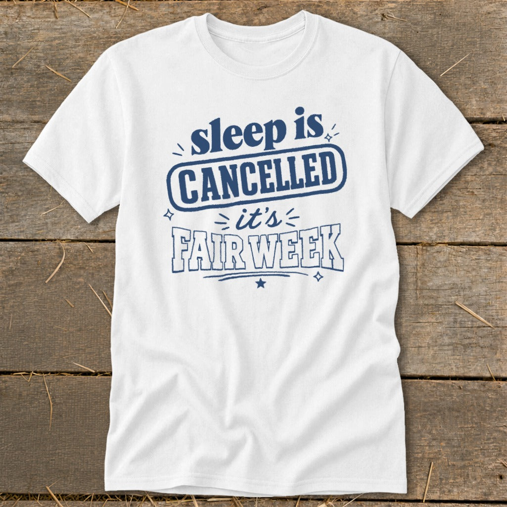 White t-shirt with blue text reading "sleep is CANCELLED = it's FAIR WEEK".