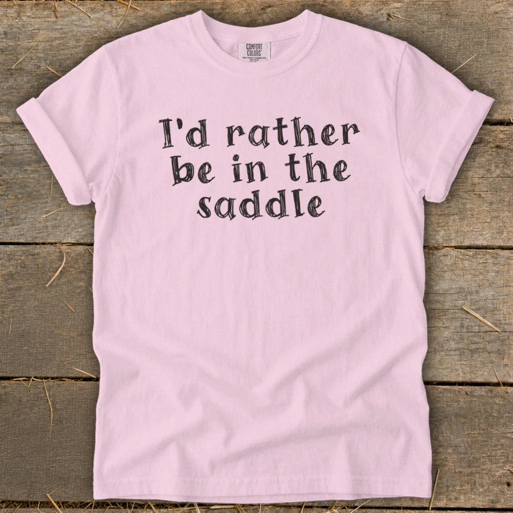 Pink t-shirt with "I'd rather be in the saddle" text.