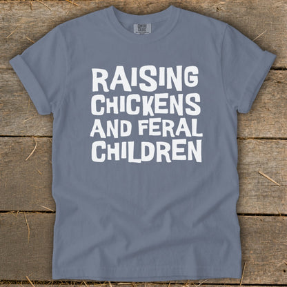 T-shirt with white text "Raising Chickens And Feral Children"