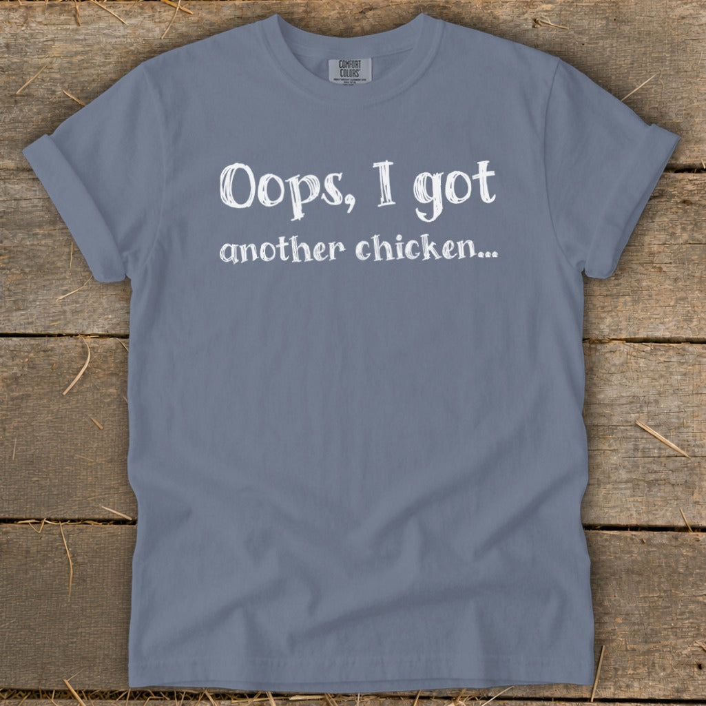 Blue t-shirt with white text: "Oops, I got another chicken..."