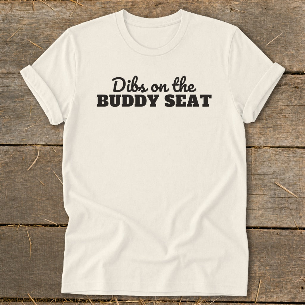 Cream t-shirt with black text "Dibs on the BUDDY SEAT".