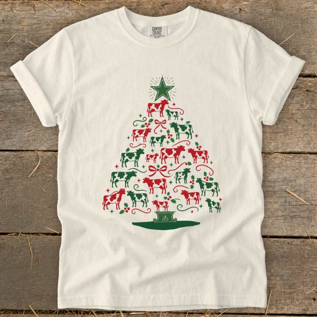 Christmas tree made of red and green cows and holly on a cream t-shirt.