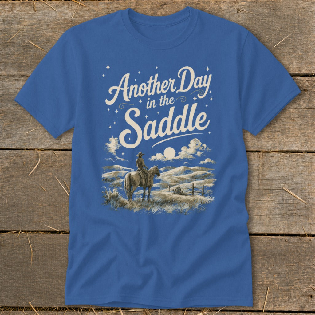 Blue t-shirt with "Another Day in the Saddle" text and a cowboy on horseback.