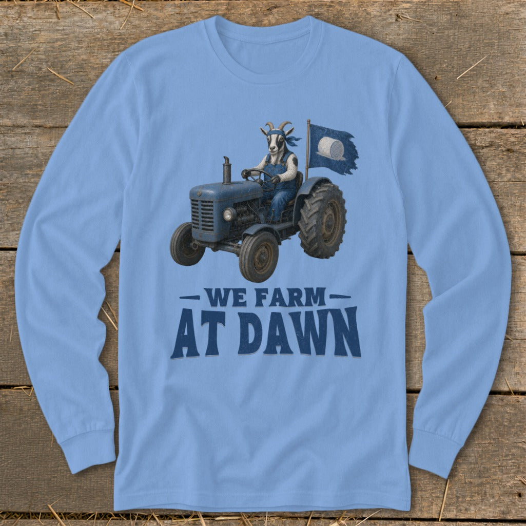 Light blue long sleeve shirt with a goat driving a tractor, text "WE FARM AT DAWN".