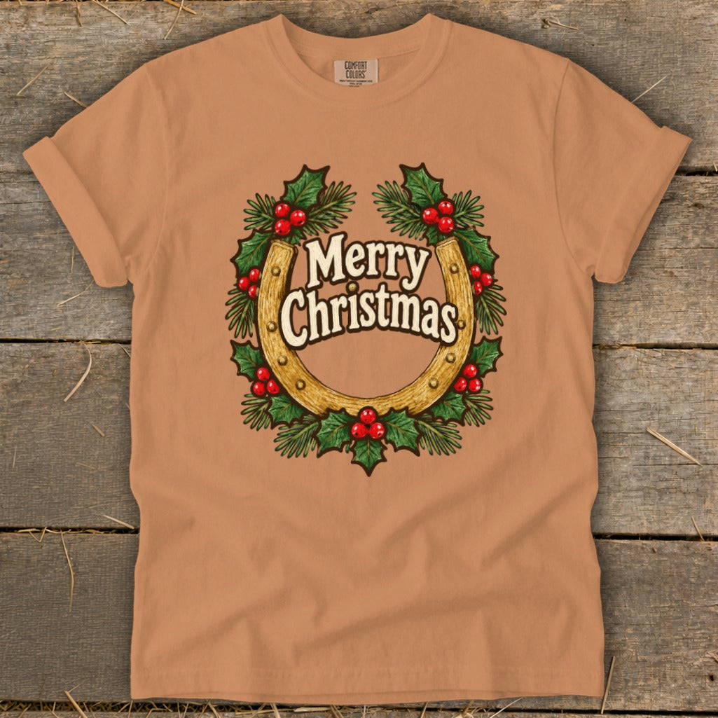 Peach t-shirt with horseshoe, holly, and "Merry Christmas" graphic.