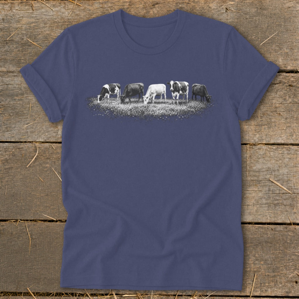 T-shirt with a graphic of five cows grazing in a field.