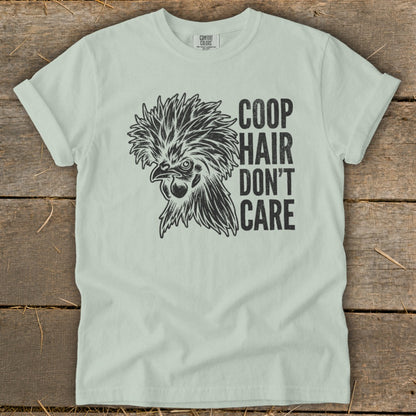 Light green t-shirt with black illustration of a chicken and text "COOP HAIR DON'T CARE".