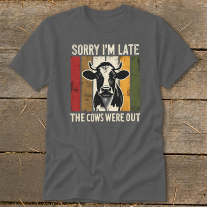 Dark gray t-shirt with a cow graphic and text "Sorry I'm Late The Cows Were Out".