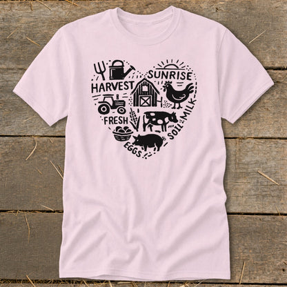 Pink t-shirt with a heart-shaped farm graphic including a tractor, barn, animals, and text.
