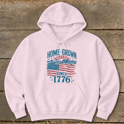 Pink hoodie with "HOME-GROWN SINCE 1776" text and distressed American flag graphic.