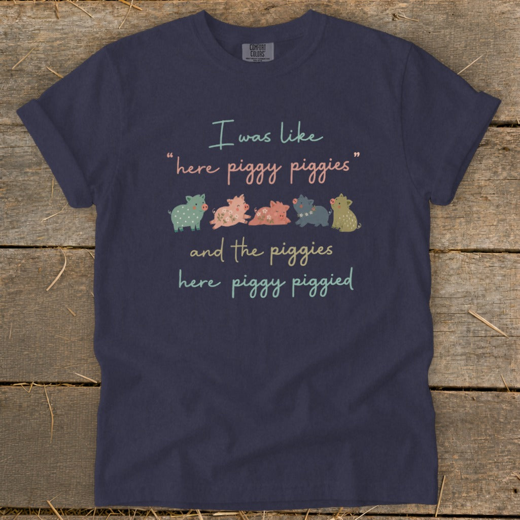 Navy t-shirt with text: "I was like 'here piggy piggies' and the piggies here piggy piggied"