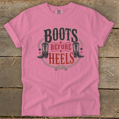 Pink t-shirt with "Boots Before Heels" text, cowboy boots, and rope graphic.