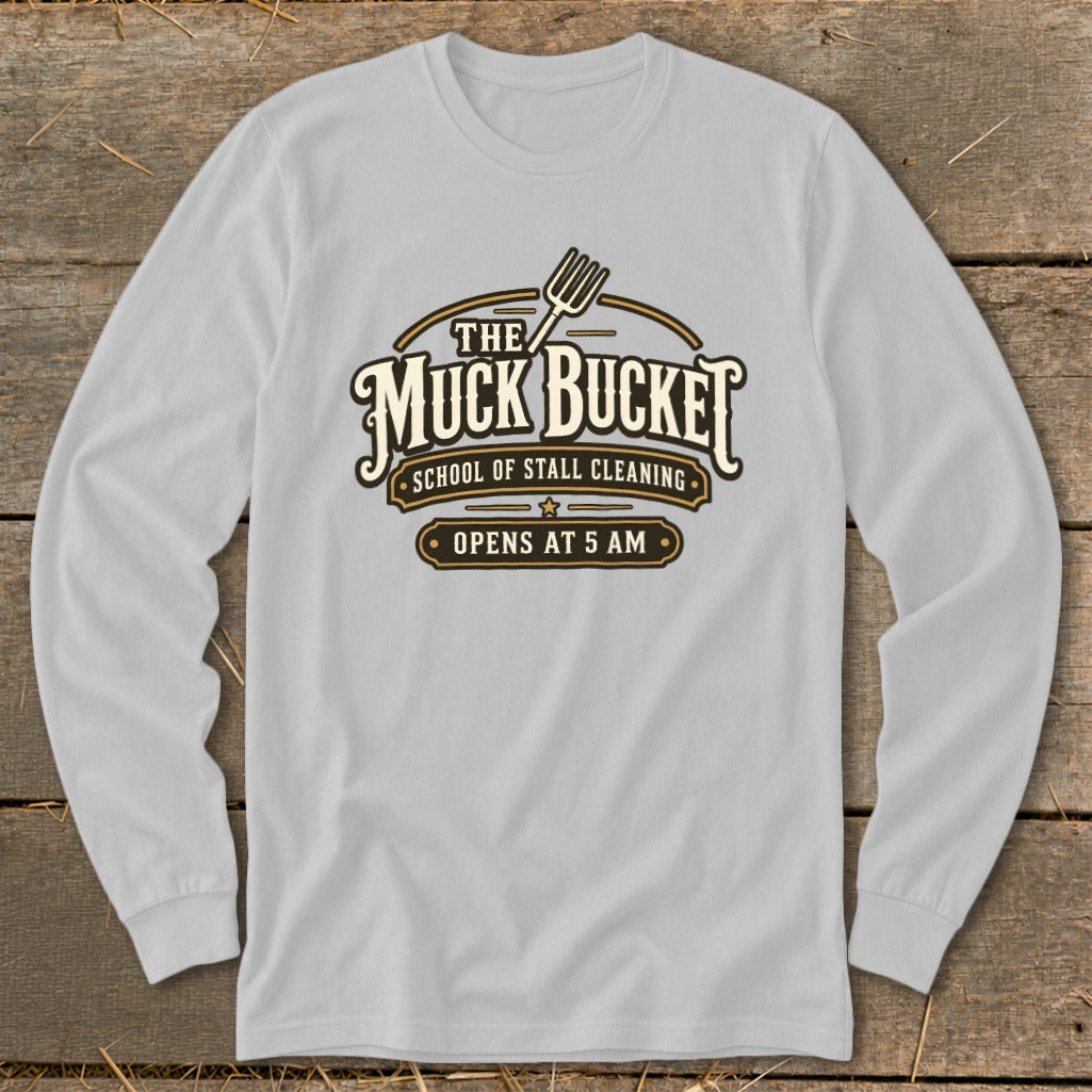 Light gray long-sleeve shirt with "The Muck Bucket School of Stall Cleaning Opens at 5 AM" logo.