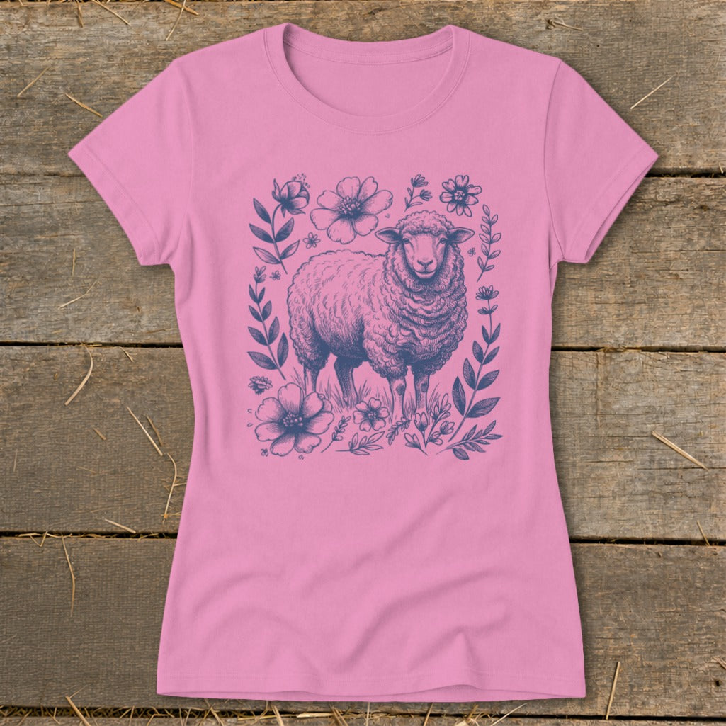 Pink t-shirt with a navy blue illustration of a sheep among flowers and leaves.