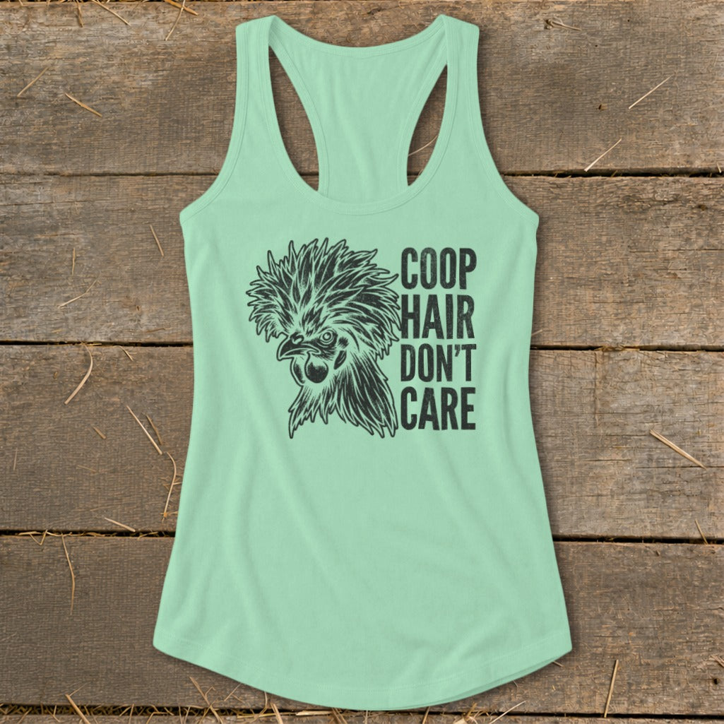 Mint green tank top with black graphic of a fluffy chicken and text "COOP HAIR DON'T CARE".