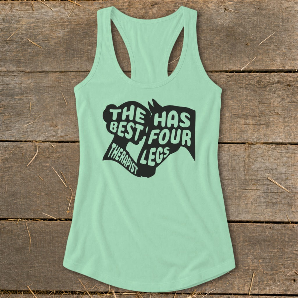 Light green tank top with black graphic reading "The best therapist has four legs".
