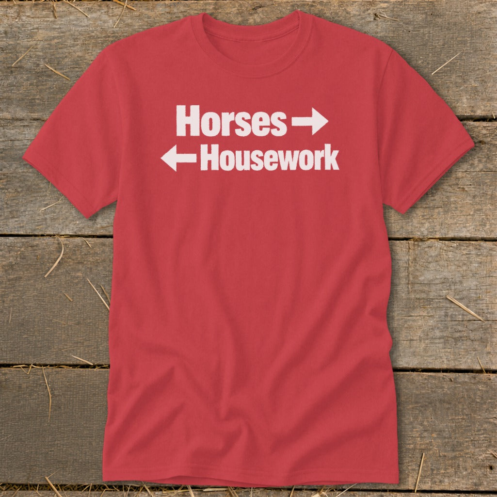 Red short-sleeve t-shirt with white text reading Horses and Housework, featuring directional arrows.