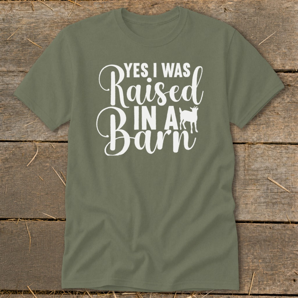 Green t-shirt with white text reading "YES I WAS Raised IN A Barn" and a goat silhouette.