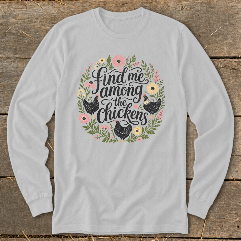 Long sleeve shirt with floral wreath and "Find me among the chickens" text.