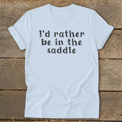 Light blue t-shirt with black text "I'd rather be in the saddle."
